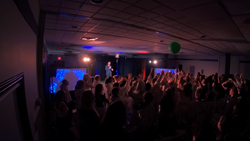 The audience stands to particpate in some mindreading with Aaron Paterson, magician from Toronto